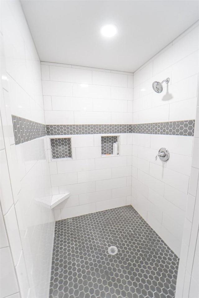 full bath featuring a tile shower