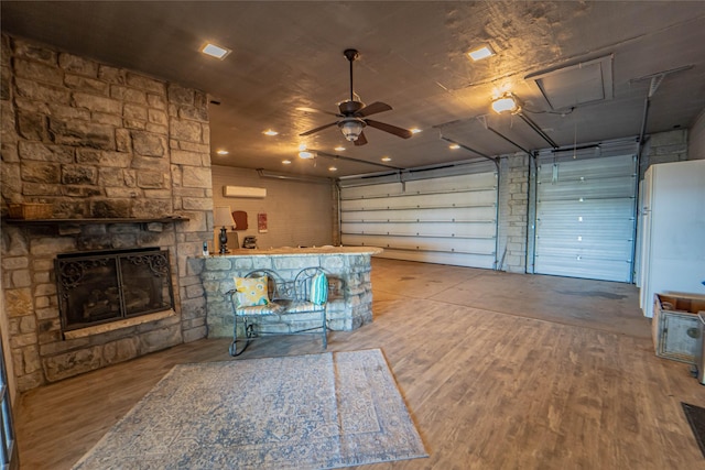 interior space featuring a ceiling fan and a stone fireplace