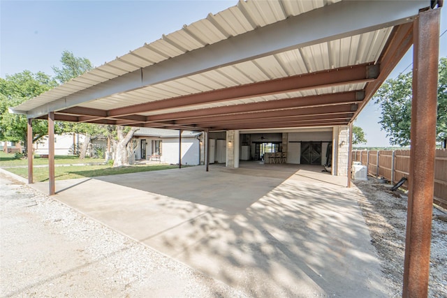view of parking with fence