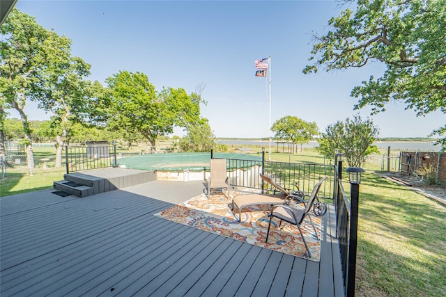 wooden deck with a lawn and fence