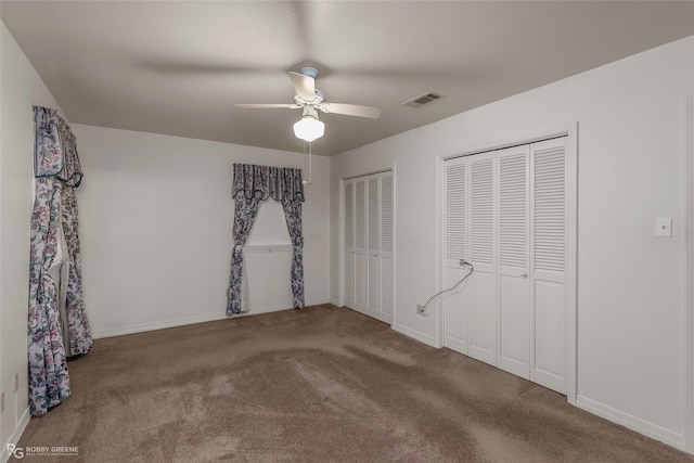 2007 Venus Dr, Bossier City, LA 71112 - unfurnished bedroom with carpet flooring, two closets, visible vents, baseboards, and ceiling fan