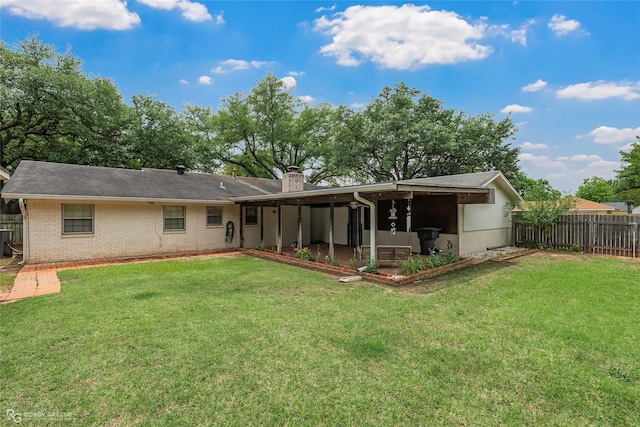 2007 Venus Dr, Bossier City, LA 71112 - rear view of house featuring a yard, brick siding, a chimney, and fence