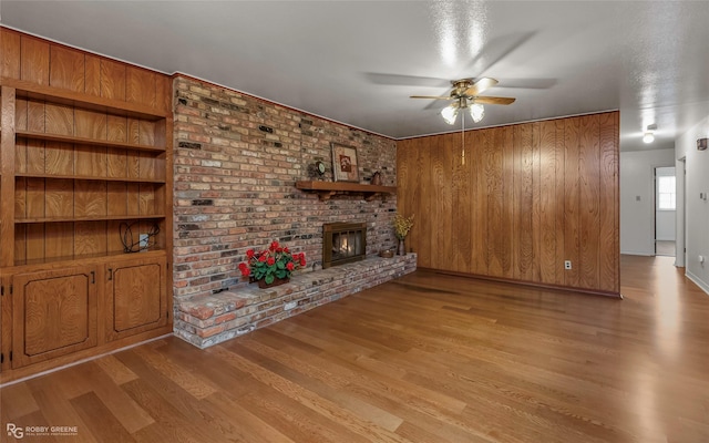 2007 Venus Dr, Bossier City, LA 71112 - unfurnished living room with a brick fireplace, ceiling fan, and wood finished floors