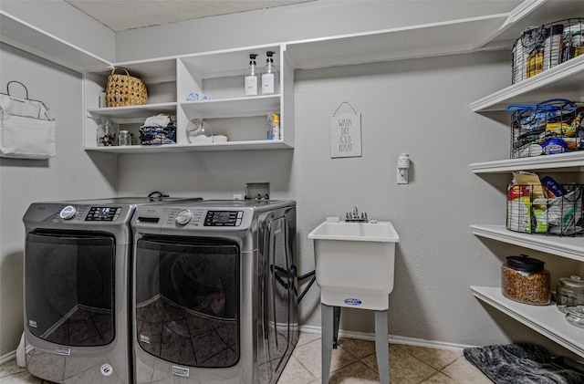 139 Wembley Way, Rockwall, TX 75032 - washroom featuring laundry area, a sink, light tile patterned flooring, baseboards, and separate washer and dryer