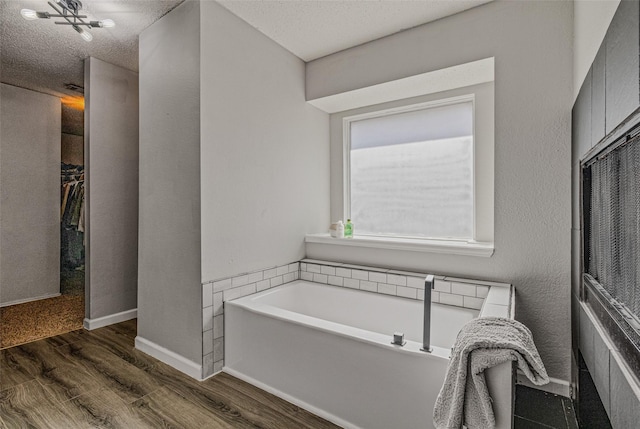 139 Wembley Way, Rockwall, TX 75032 - full bath featuring a bath and wood finished floors