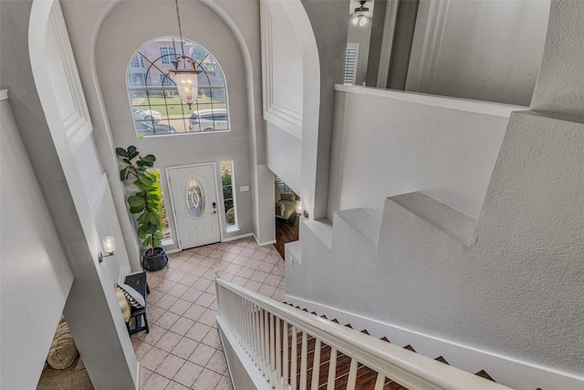 139 Wembley Way, Rockwall, TX 75032 - foyer with stairway, an inviting chandelier, a high ceiling, and light tile patterned floors