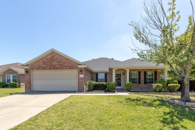 717 Baldwin Rd, Wylie, TX 75098 - single story home featuring a garage, brick siding, a front lawn, and concrete driveway
