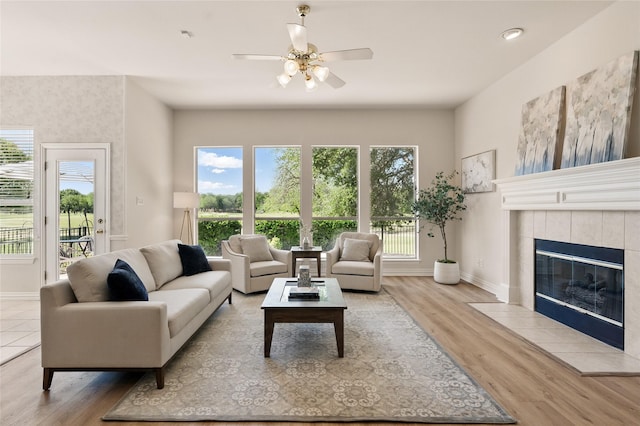 2110 Watercrest Ct, Keller, TX 76248 - living area featuring ceiling fan, a tile fireplace, baseboards, and wood finished floors