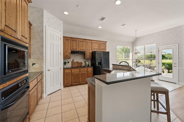 2110 Watercrest Ct, Keller, TX 76248 - kitchen with a kitchen bar, black appliances, a sink, and wallpapered walls