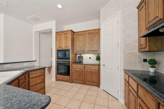 2110 Watercrest Ct, Keller, TX 76248 - kitchen featuring under cabinet range hood, brown cabinets, black appliances, and tasteful backsplash