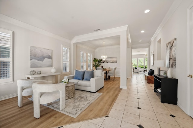 2110 Watercrest Ct, Keller, TX 76248 - living area featuring crown molding, light wood-type flooring, baseboards, a notable chandelier, and visible vents