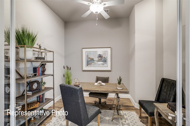 office featuring baseboards, a ceiling fan, and wood finished floors