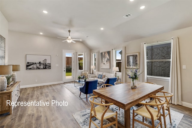 dining space with vaulted ceiling, baseboards, visible vents, light wood-style floors, and ceiling fan