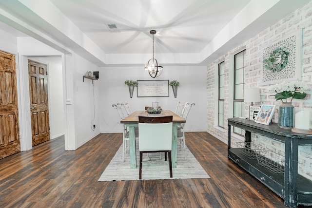 dining space with visible vents, baseboards, and wood finished floors