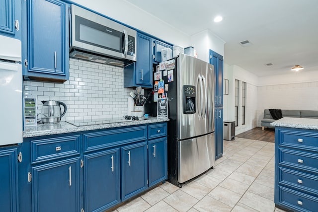 kitchen with blue cabinets, open floor plan, visible vents, and appliances with stainless steel finishes
