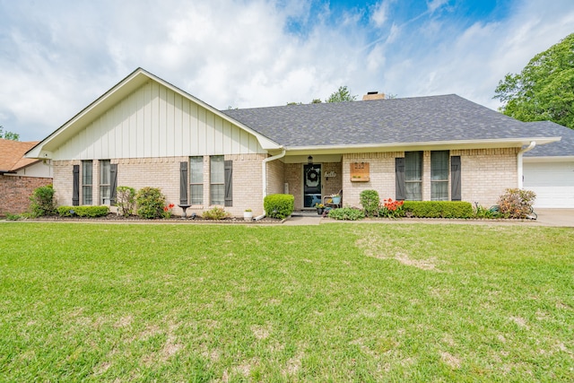 ranch-style home with brick siding, an attached garage, a front lawn, and concrete driveway