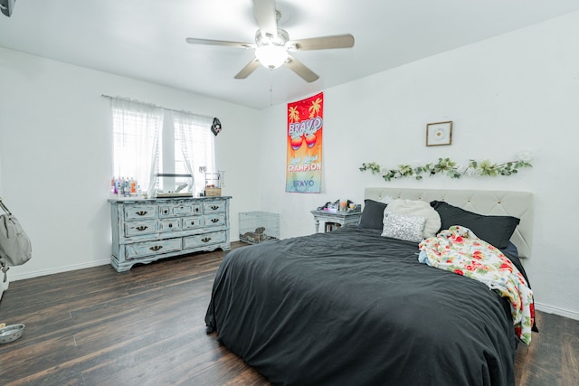 bedroom featuring baseboards, dark wood-style floors, and ceiling fan