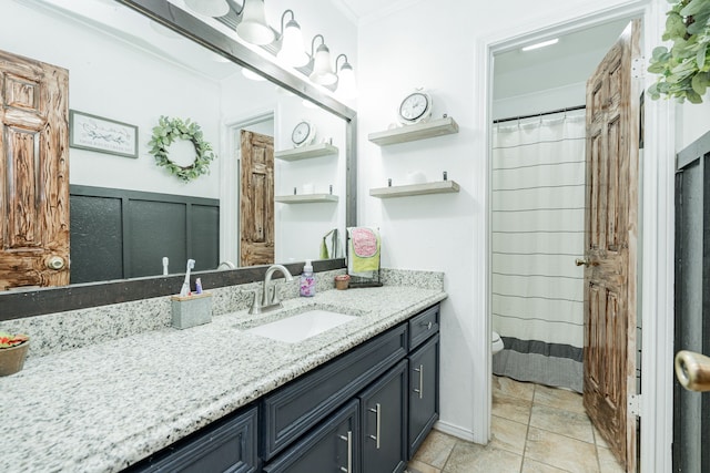 full bath featuring toilet, vanity, and crown molding