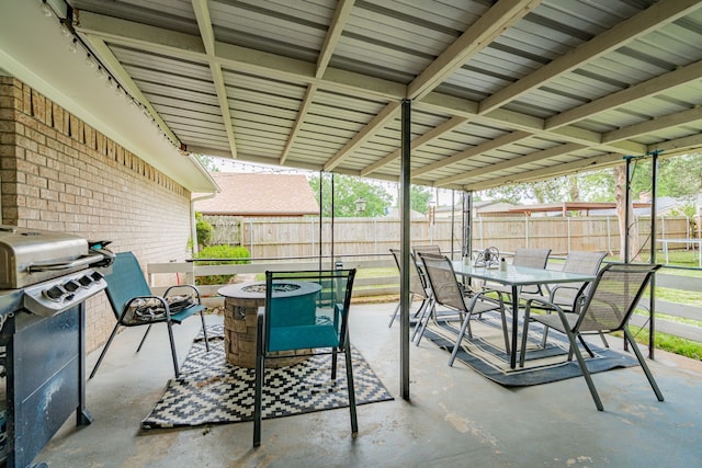 view of patio / terrace with a fire pit, area for grilling, a fenced backyard, and outdoor dining area