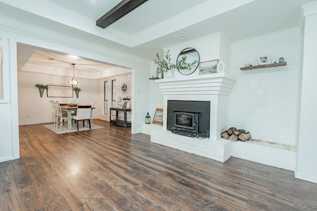 living area with baseboards, wood finished floors, and a fireplace