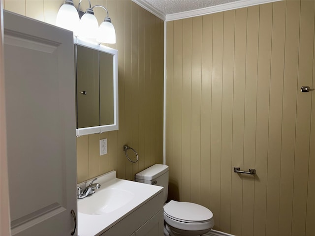 3741 Trinity Ln, Abilene, TX 79602 - half bath featuring ornamental molding, vanity, toilet, and wood walls
