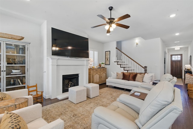 579 Point Vista Dr, Aledo, TX 76008 - living area with wood finished floors, a ceiling fan, a fireplace with raised hearth, stairway, and recessed lighting