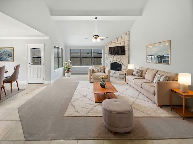 tiled living area featuring beam ceiling, baseboards, ceiling fan, a stone fireplace, and high vaulted ceiling