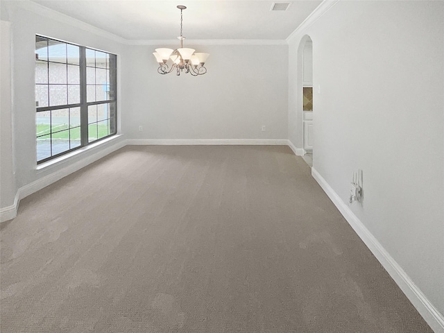 carpeted empty room featuring arched walkways, ornamental molding, a chandelier, and baseboards