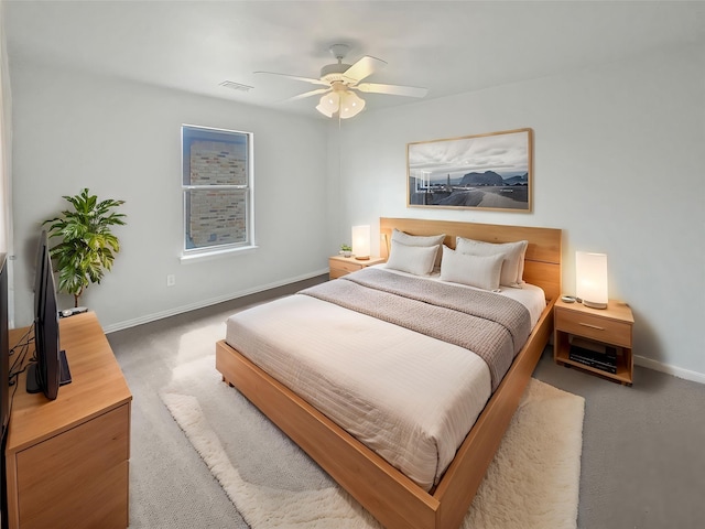 carpeted bedroom featuring baseboards, visible vents, and ceiling fan
