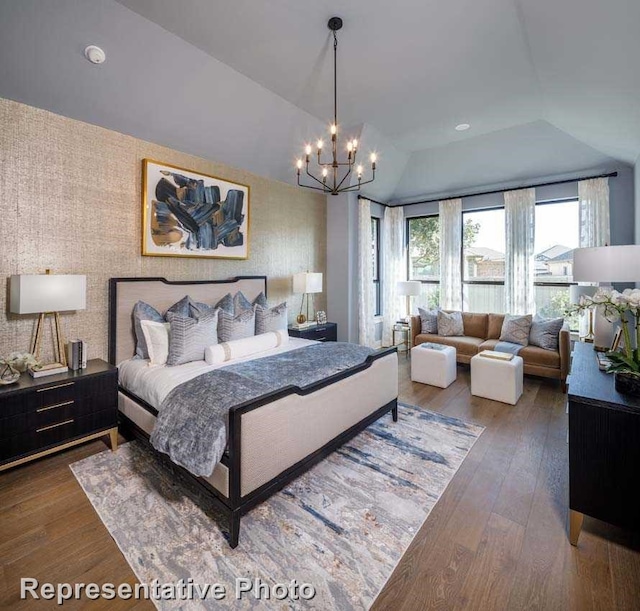 bedroom with wood-type flooring, vaulted ceiling, a notable chandelier, and wallpapered walls