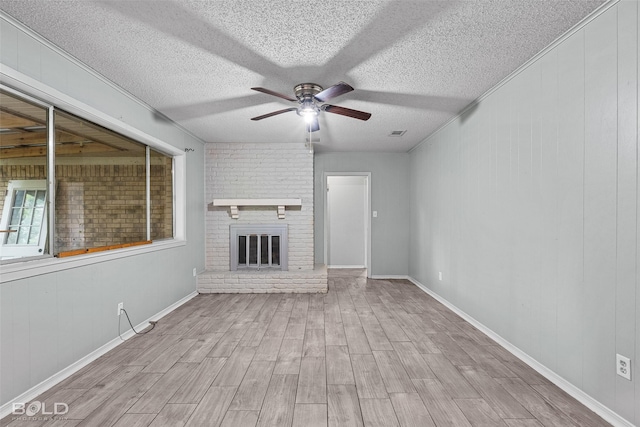 1908 Bey St, Bossier City, LA 71112 - unfurnished living room featuring wood finished floors, a fireplace, visible vents, a ceiling fan, and a textured ceiling