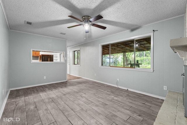 1908 Bey St, Bossier City, LA 71112 - unfurnished living room featuring ornamental molding, a ceiling fan, wood finished floors, and a textured ceiling