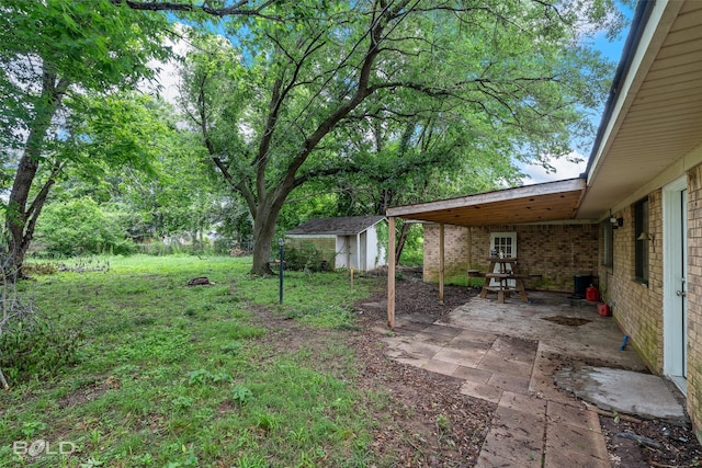 1908 Bey St, Bossier City, LA 71112 - view of yard featuring an outdoor structure, a shed, and a patio area