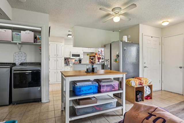 911 Turtle Lake Blvd, Irving, TX 75060 - kitchen featuring a textured ceiling, white microwave, a ceiling fan, independent washer and dryer, and light tile patterned floors