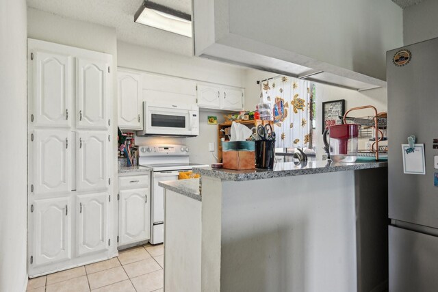 911 Turtle Lake Blvd, Irving, TX 75060 - kitchen with white cabinets, light stone countertops, light tile patterned floors, and white appliances