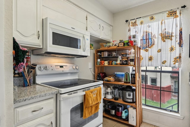 911 Turtle Lake Blvd, Irving, TX 75060 - kitchen with white cabinets, white appliances, and light tile patterned floors