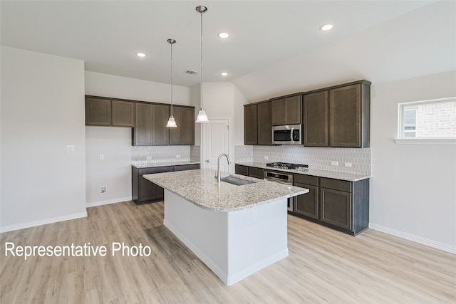 4933 Hitching Post Dr, Fort Worth, TX 76036 - kitchen featuring dark brown cabinets, a sink, stainless steel appliances, light wood-style flooring, and backsplash