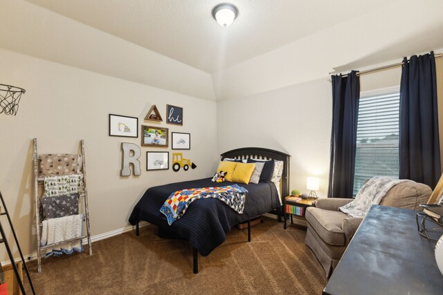 bedroom with baseboards, dark carpet, and lofted ceiling