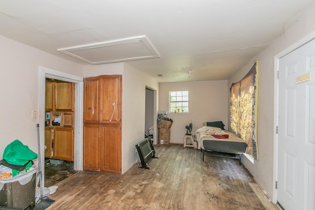 bedroom featuring attic access, hardwood / wood-style floors, and visible vents