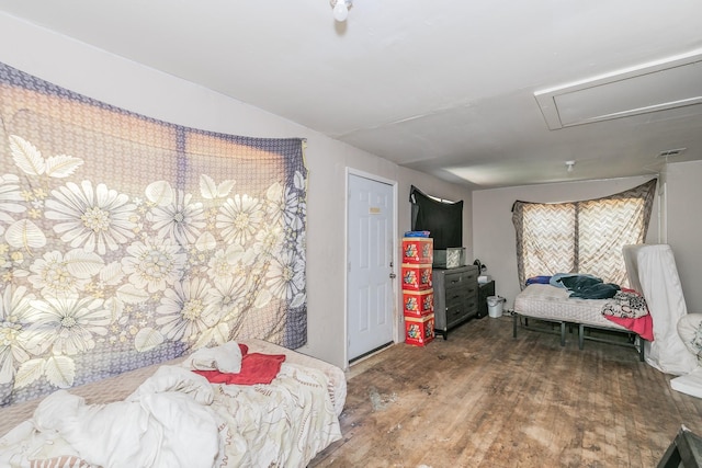 bedroom with attic access and wood finished floors