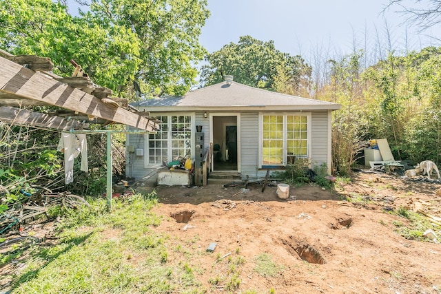 rear view of house with a pergola and entry steps