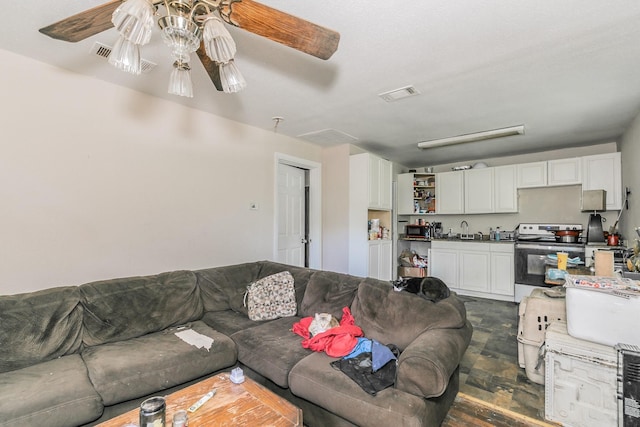 living area with visible vents and a ceiling fan