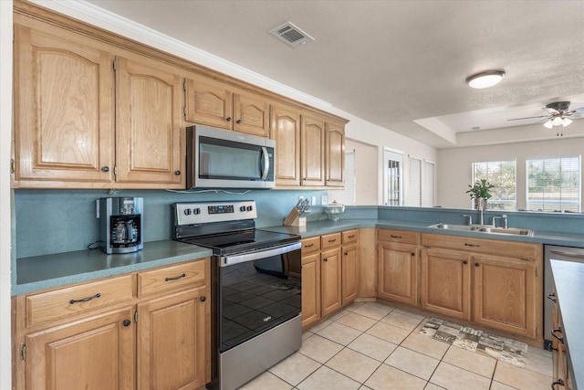 kitchen with stainless steel appliances, a sink, visible vents, a ceiling fan, and light tile patterned floors