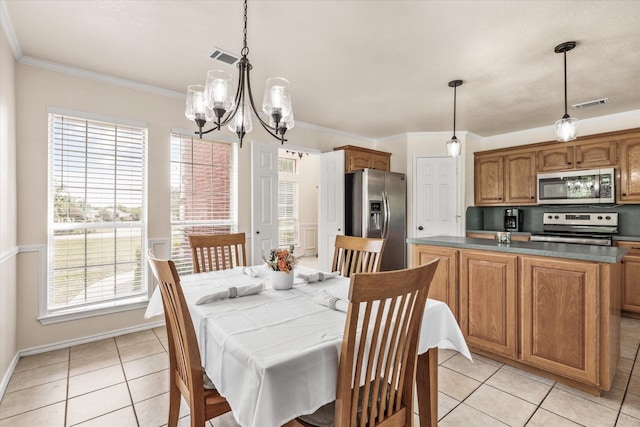 dining room with visible vents, a chandelier, ornamental molding, and light tile patterned flooring