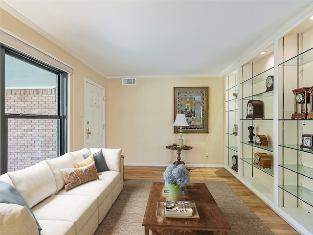 823 Cliffdale Ave, Dallas, TX 75211 - living room featuring wood finished floors, visible vents, baseboards, and ornamental molding