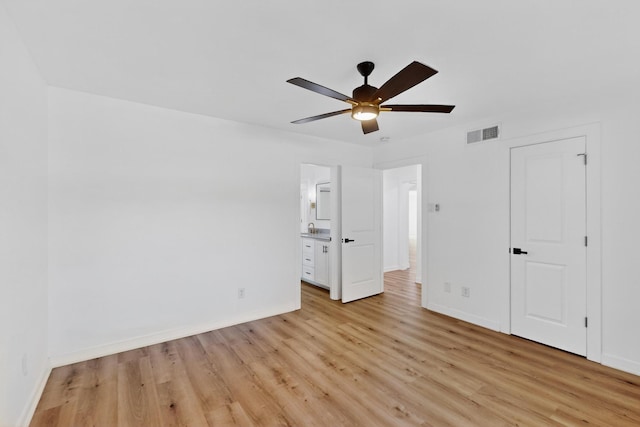 7116 Town Bluff Dr, Dallas, TX 75248 - unfurnished bedroom with light wood-style floors, baseboards, ensuite bathroom, and a ceiling fan