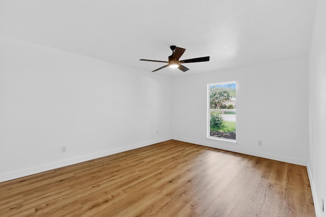 7116 Town Bluff Dr, Dallas, TX 75248 - spare room with light wood-style flooring, a ceiling fan, and baseboards