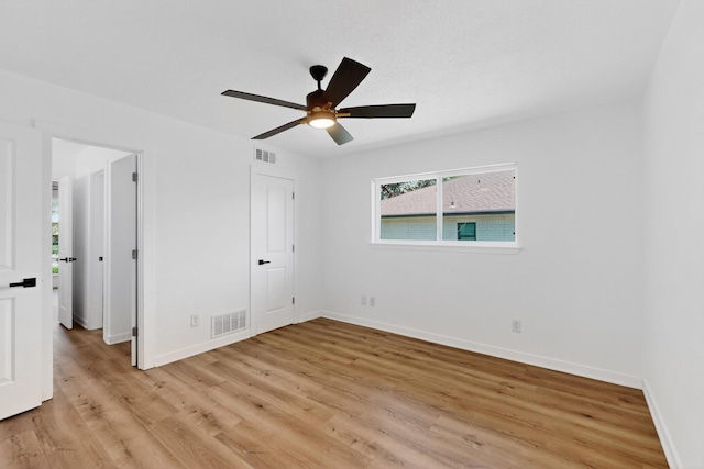 7116 Town Bluff Dr, Dallas, TX 75248 - unfurnished bedroom featuring light wood-style floors, baseboards, and ceiling fan