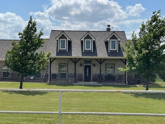 cape cod house with fence private yard, a porch, a front lawn, and a shingled roof