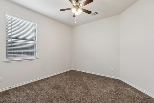 carpeted spare room featuring ceiling fan, baseboards, and visible vents